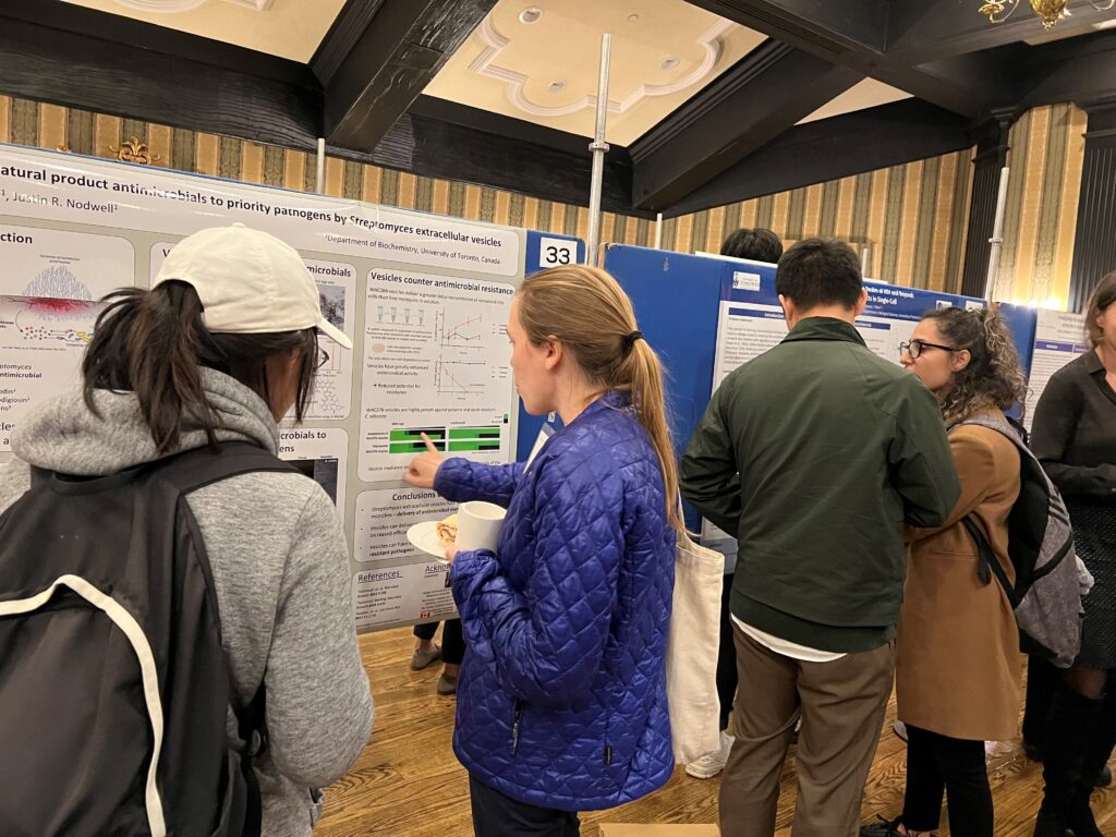 People talking around a research poster