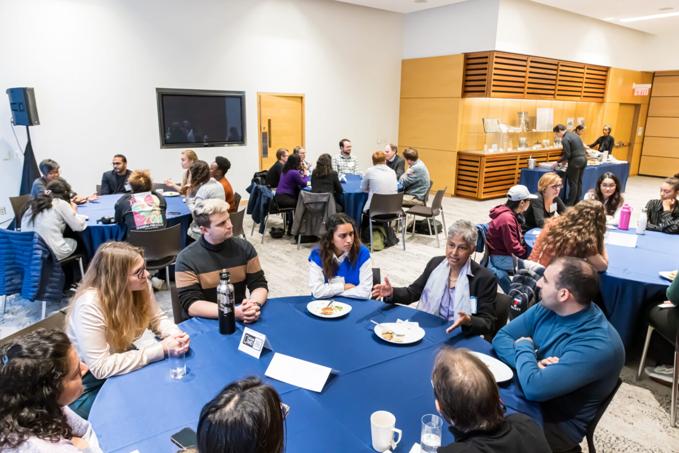 Anticlockwise: Tables with trainees connecting with Kanta Subbaro, Inger Damon, Don Sheppard and Senjuti Saha over lunch.